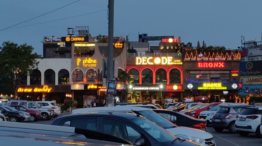 Restaurants and bars lit up in the evening on Leisure Valley Road, Sector 29, Gurgaon